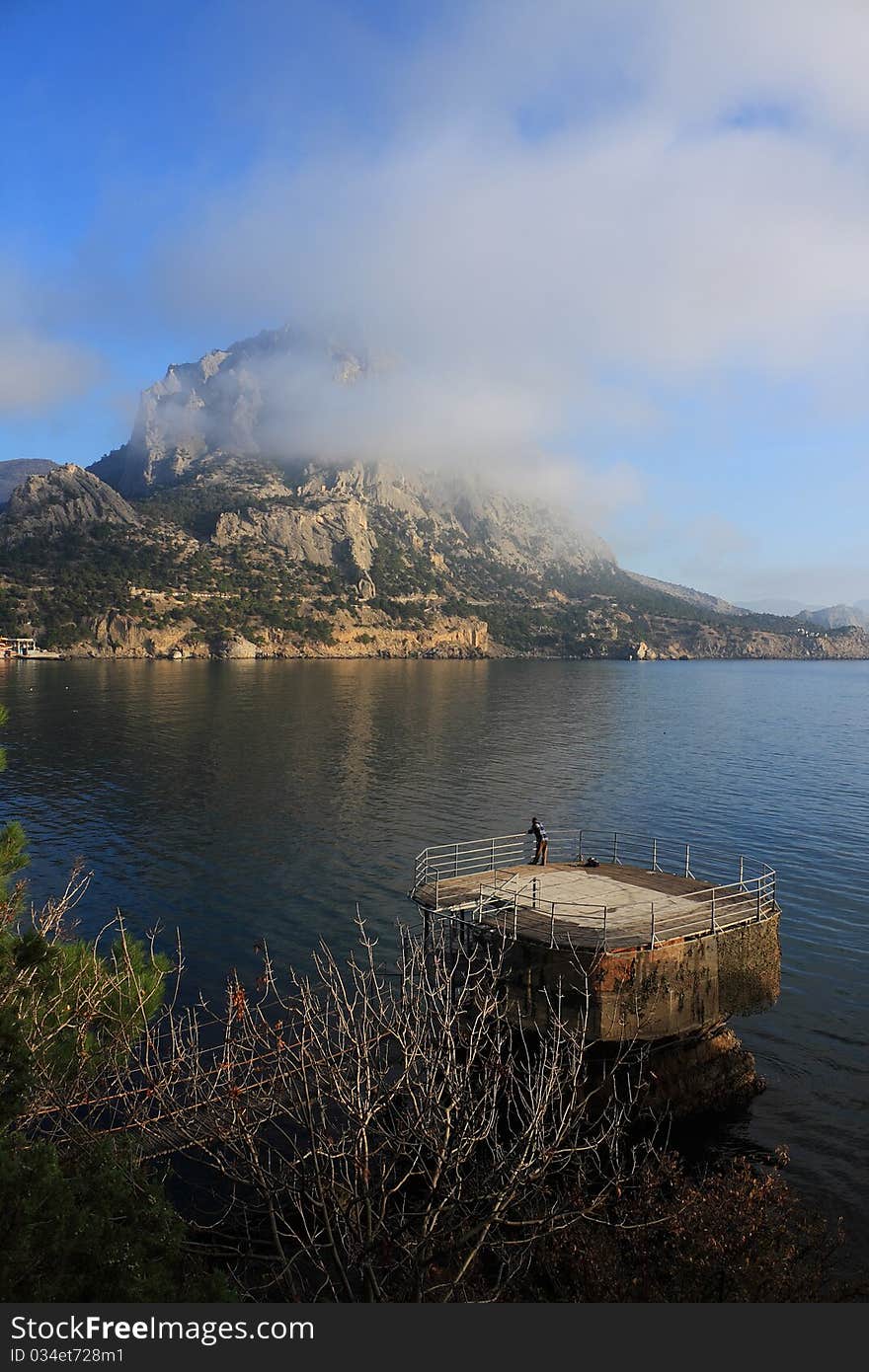 Mountain and sea landscape east of crimea. The mountains and rocks, covered with juniper and pine. Blue sea. Mountain and sea landscape east of crimea. The mountains and rocks, covered with juniper and pine. Blue sea