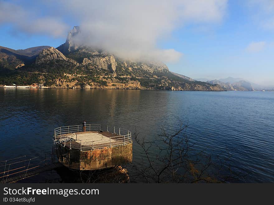 Mountain and sea landscape east of crimea. The mountains and rocks, covered with juniper and pine. Blue sea. Mountain and sea landscape east of crimea. The mountains and rocks, covered with juniper and pine. Blue sea