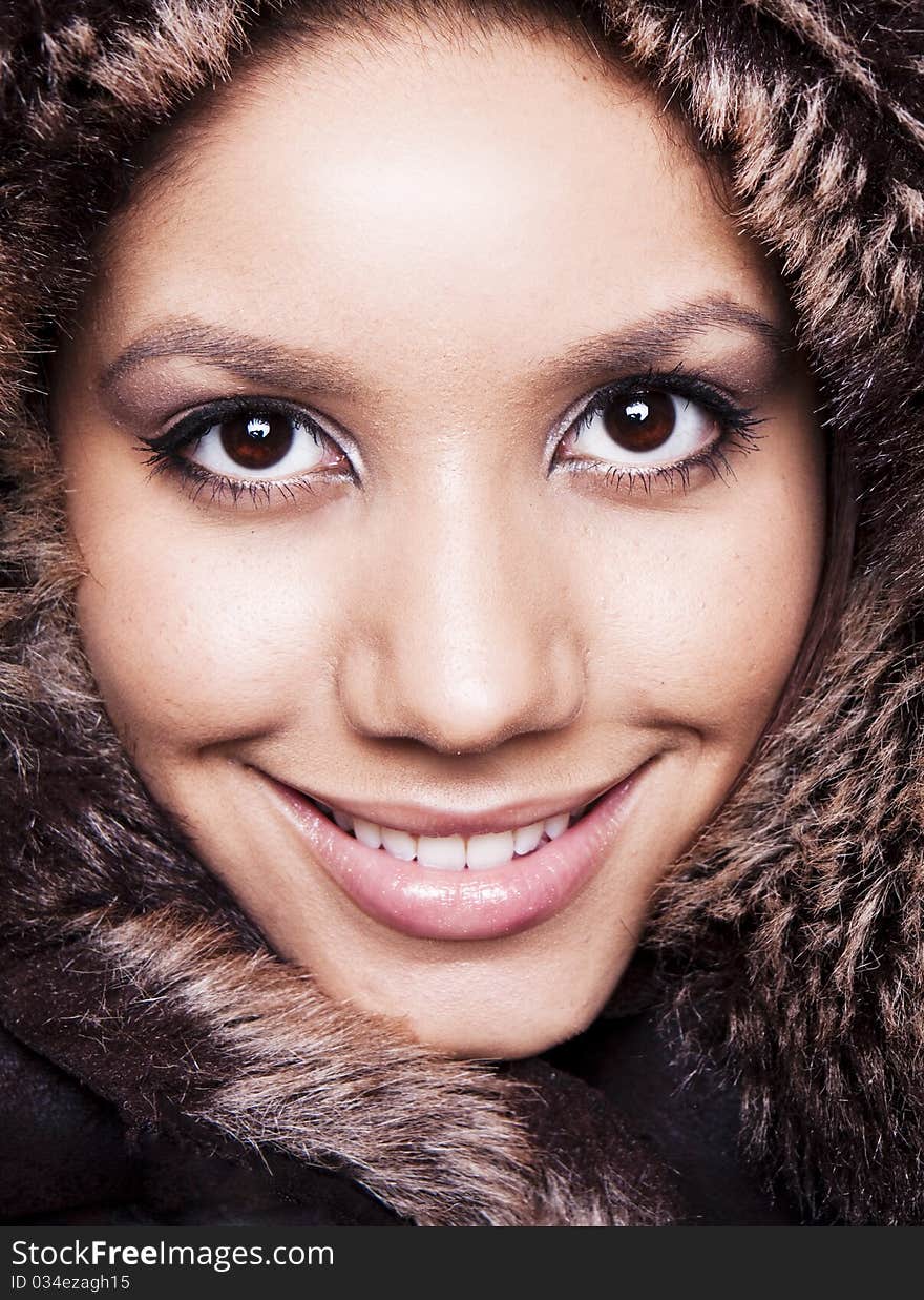 Beautiful Winter Woman smiling in a fur hat. Beautiful Winter Woman smiling in a fur hat