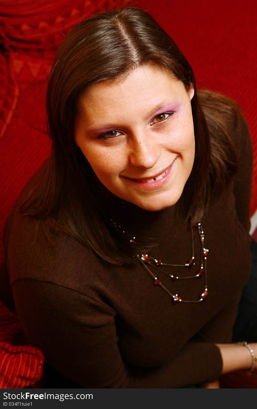 Smiling Woman on red sofa. Smiling Woman on red sofa