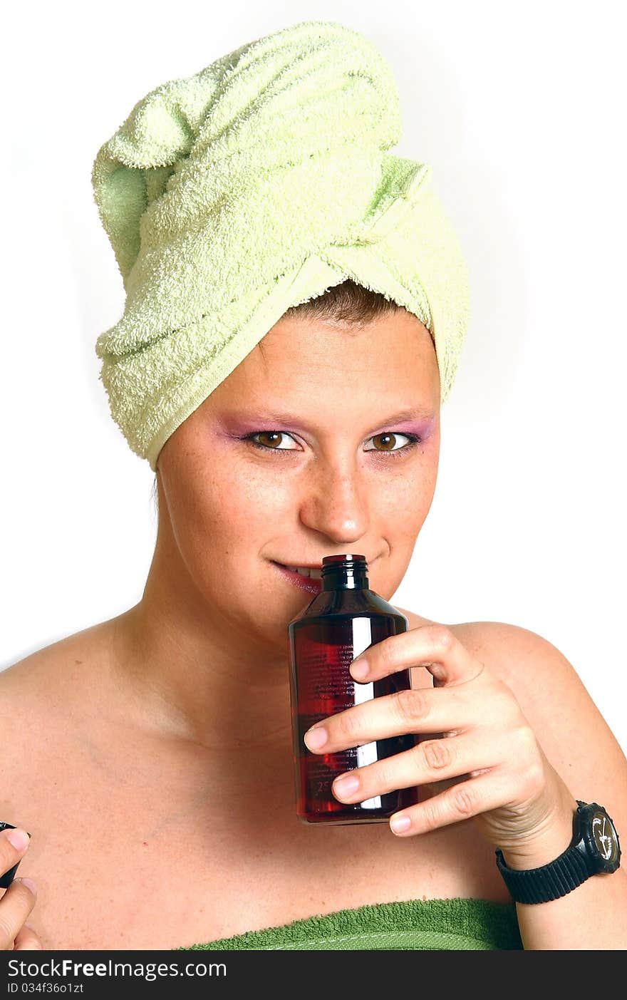 BEAUTIFUL YOUNG WOMAN SMELLING HER PERFUME