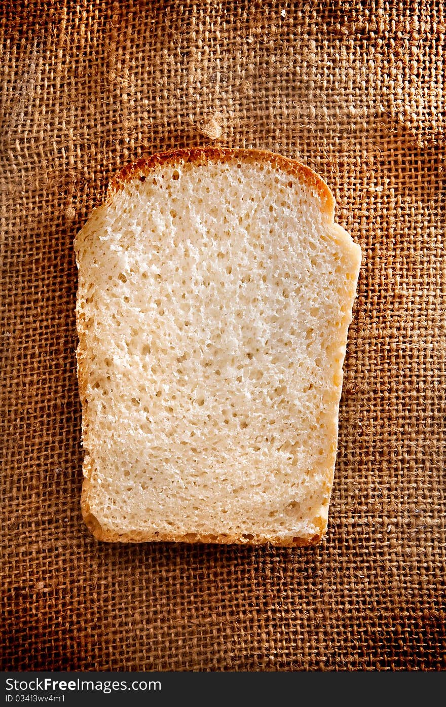 Pieces of bread on brown fabric