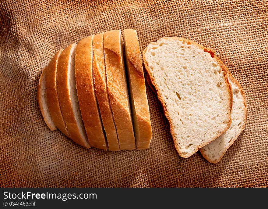 Pieces of bread on brown fabric