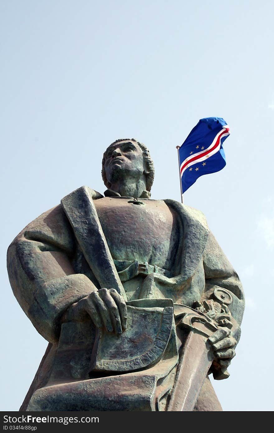 Diogo  Gomes staue on Praia city and the Cape Verde flag. Diogo  Gomes staue on Praia city and the Cape Verde flag