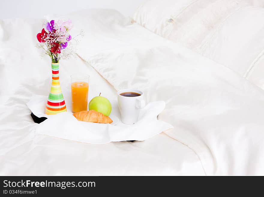 Cup of coffe and flower in vase on tray. Cup of coffe and flower in vase on tray