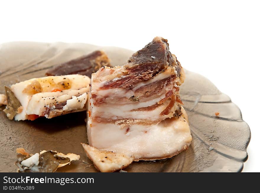 A piece of meat on a plate on a white background