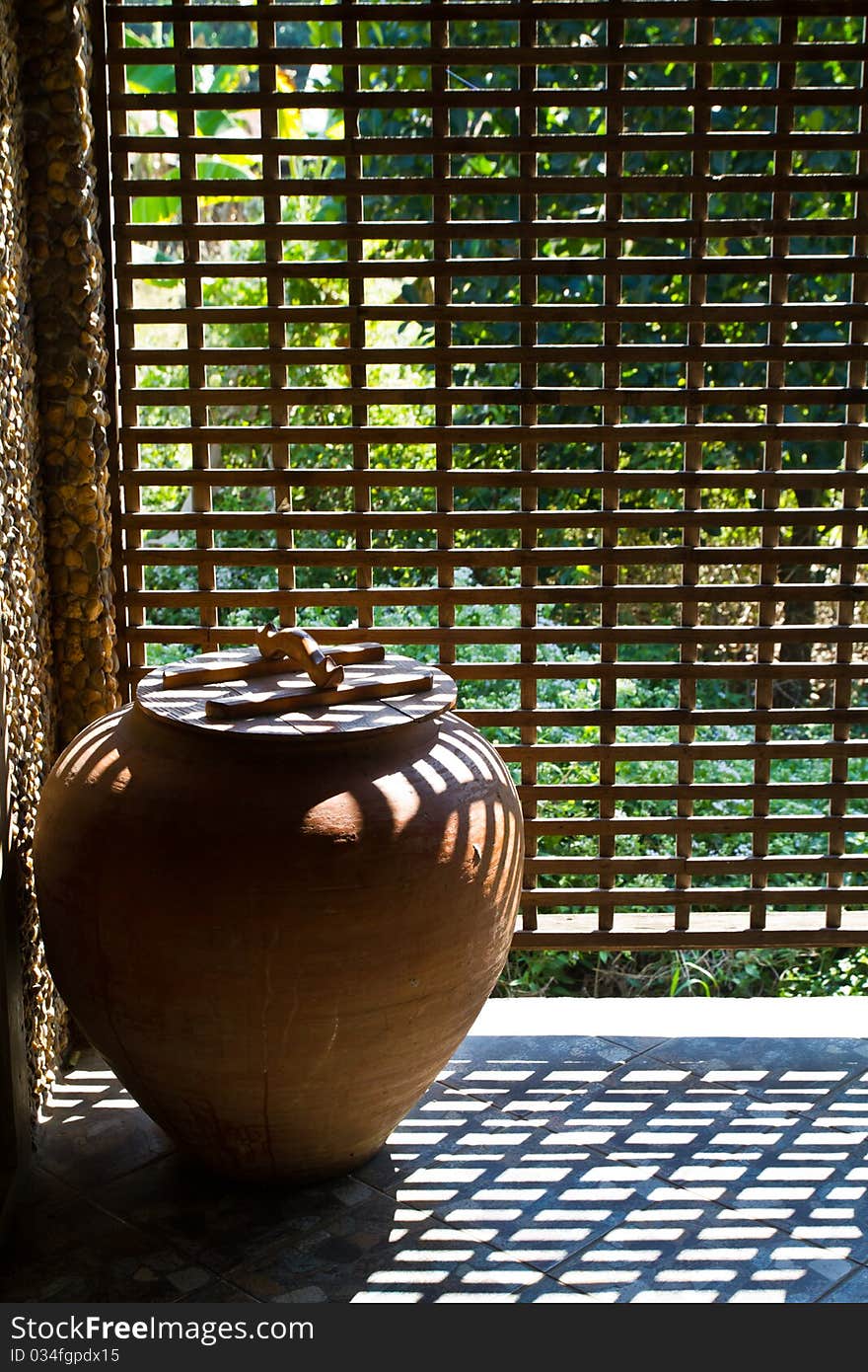 Pottery jar with ventilate wooden wall in Thai tradition bathroom. Pottery jar with ventilate wooden wall in Thai tradition bathroom