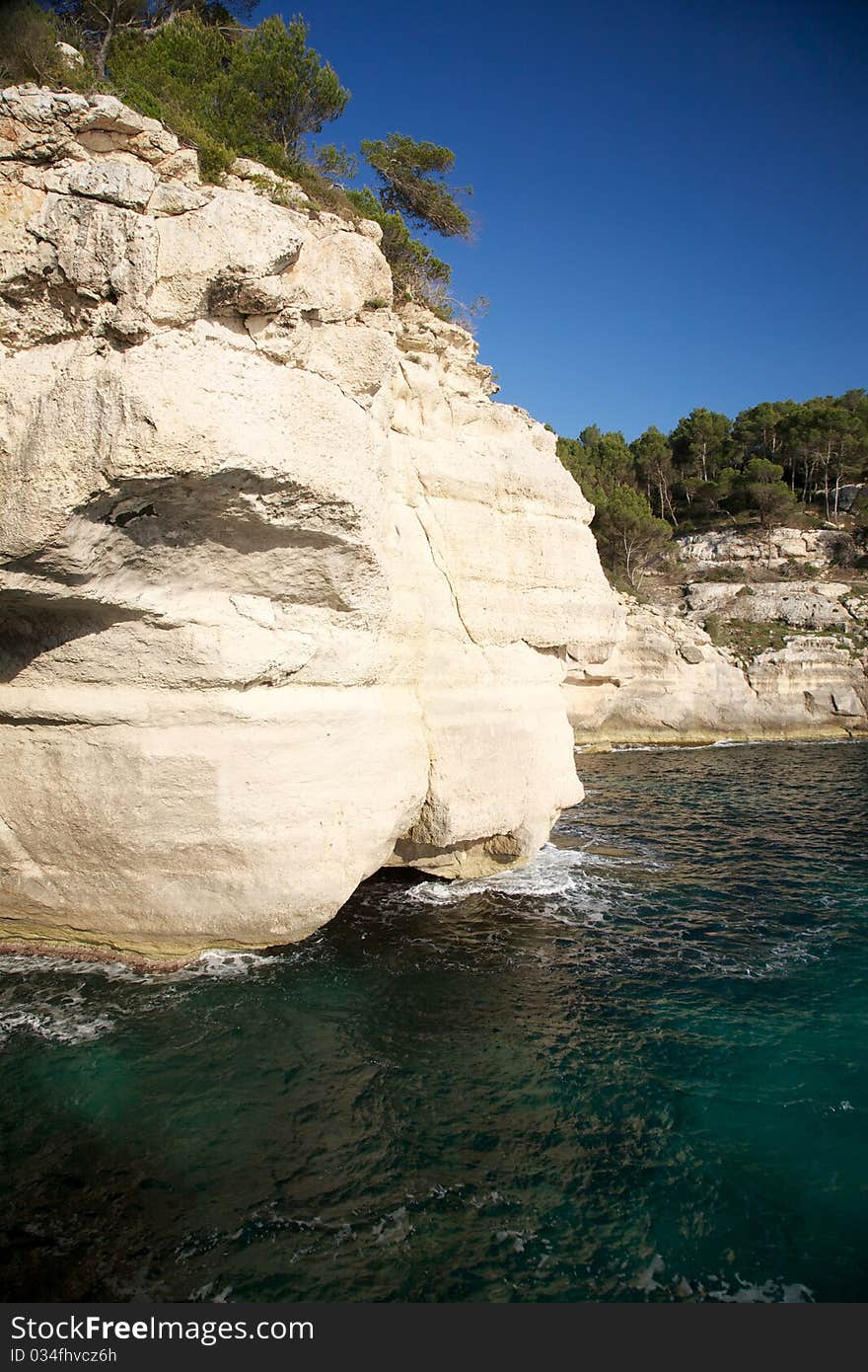 Cliff on dark green sea