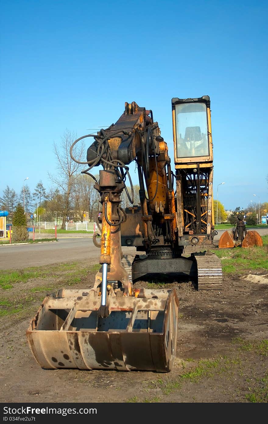 Excavator against the blue sky