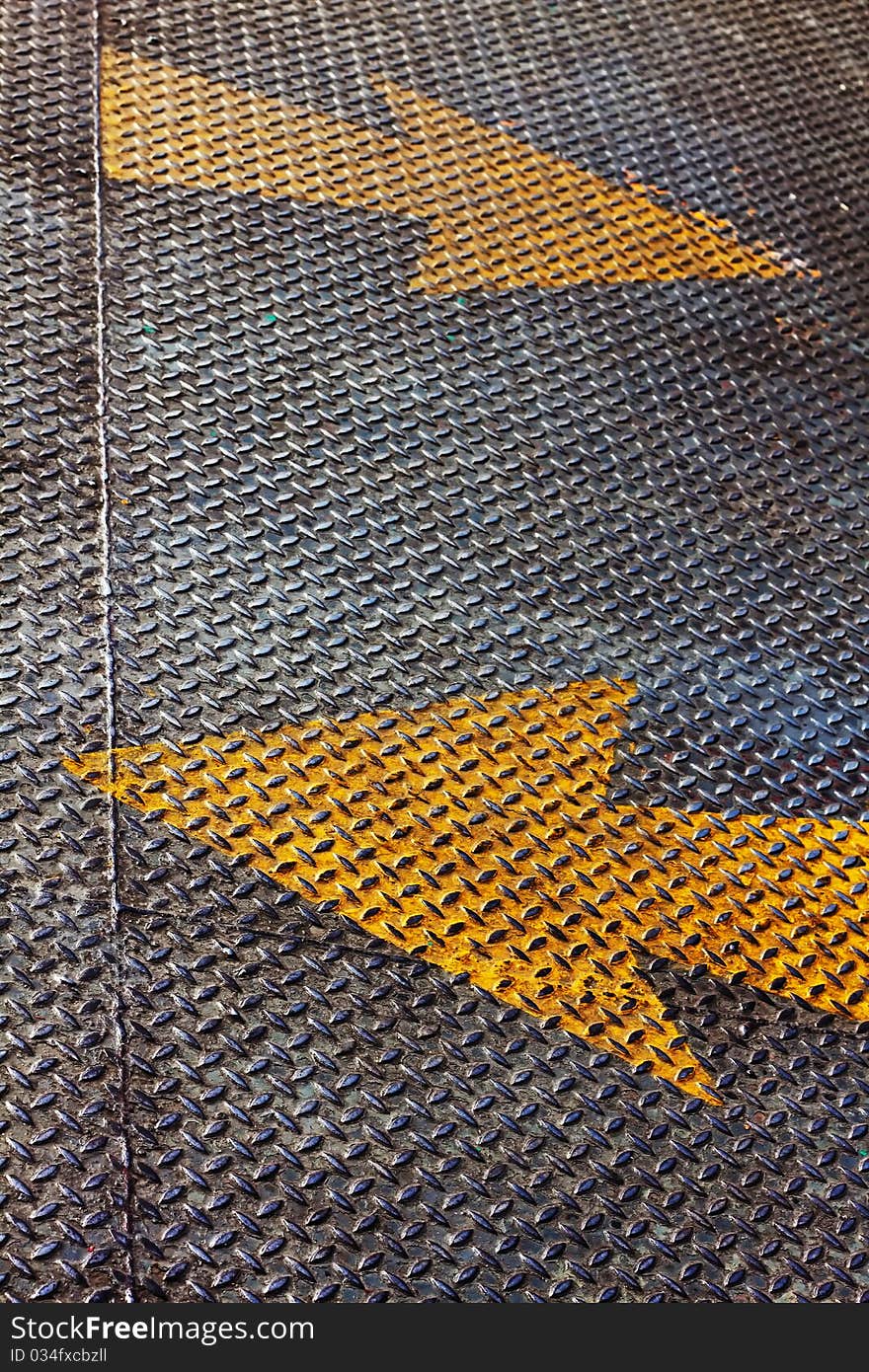 Two Yellow arrows Piant on steel floor palte