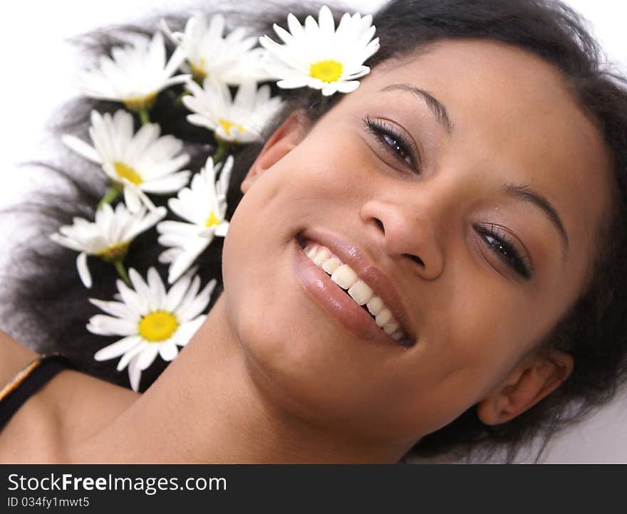 Beautiful young female with daisies in her hair - perfect for spa and wellness concepts. Beautiful young female with daisies in her hair - perfect for spa and wellness concepts.