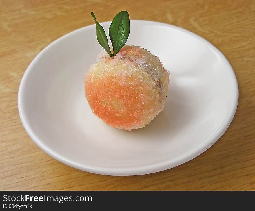 Photo of a peach-shaped sweetie on a plate