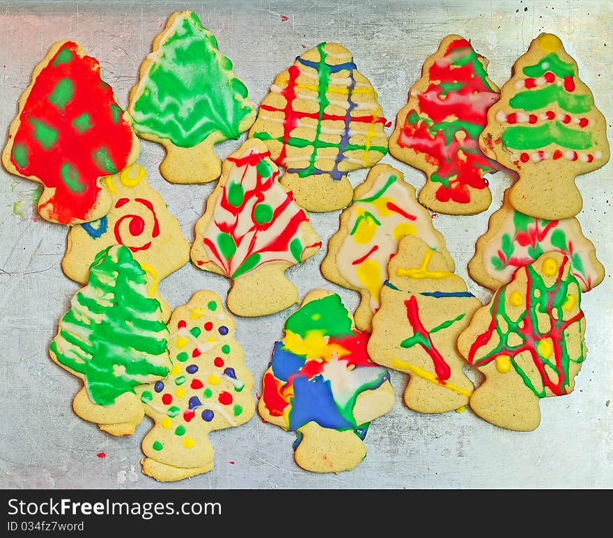 Christmas tree cookies decorated and stacked on a cookie sheet. Christmas tree cookies decorated and stacked on a cookie sheet