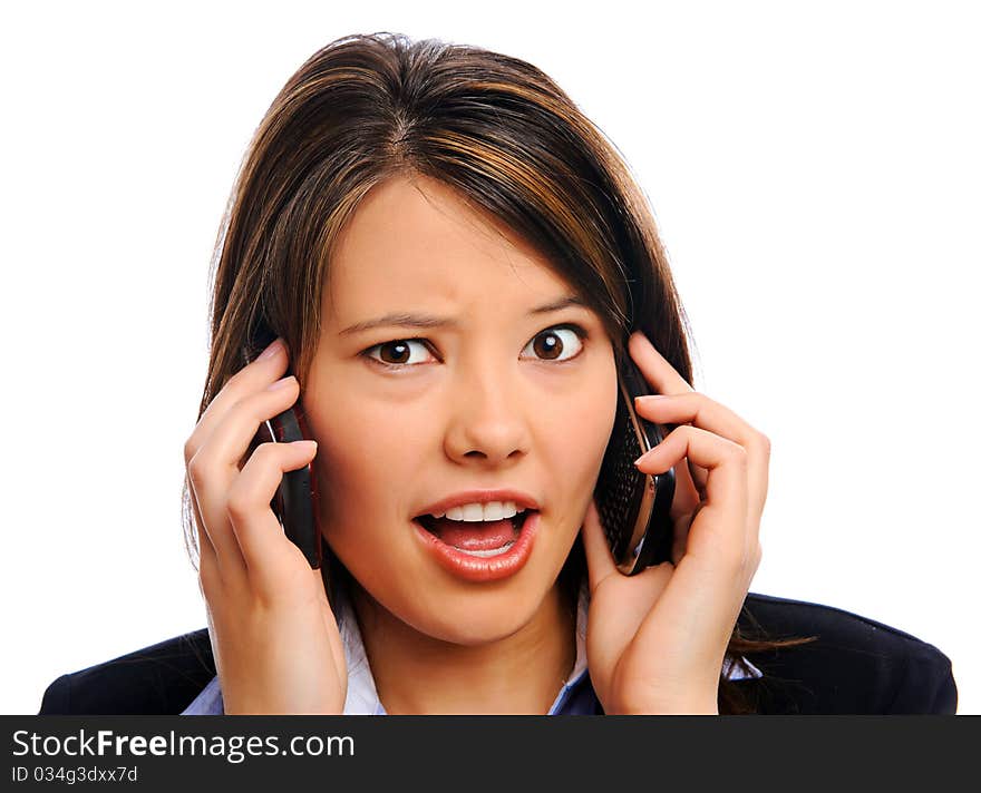 Businesswoman multitasks on two mobile phones. Businesswoman multitasks on two mobile phones