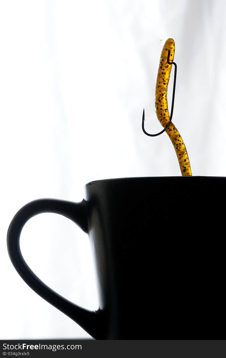 Close up image of coffee cup with fishing lure. Close up image of coffee cup with fishing lure