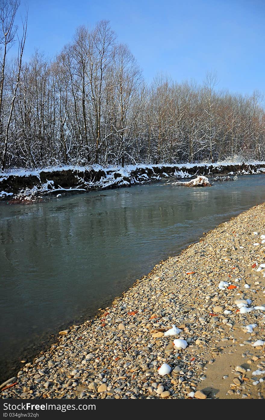 Convergent curves on rocky river in a winter sunny day