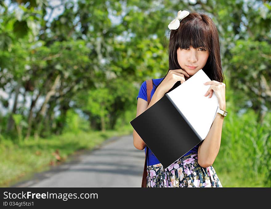 Young beautiful girl holding a big book. Young beautiful girl holding a big book