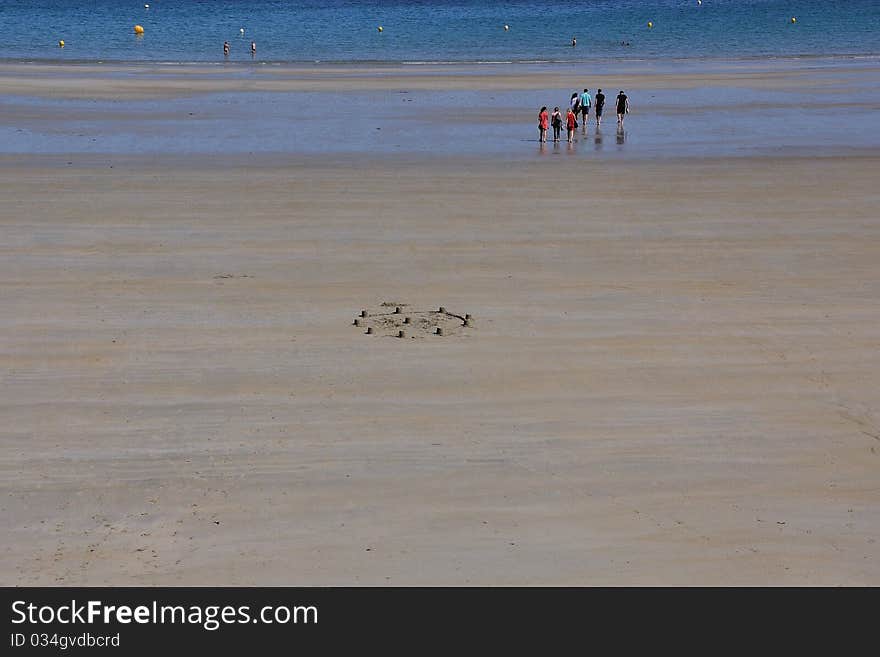 A construction with the sand in a large breton beach during the low tide. A construction with the sand in a large breton beach during the low tide