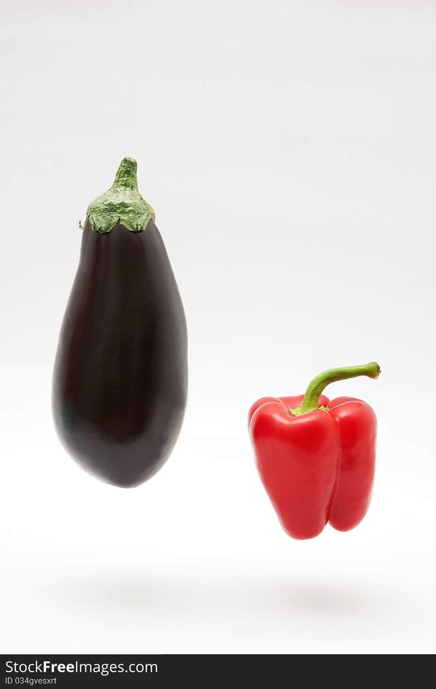 Eggplant and pepper on white background