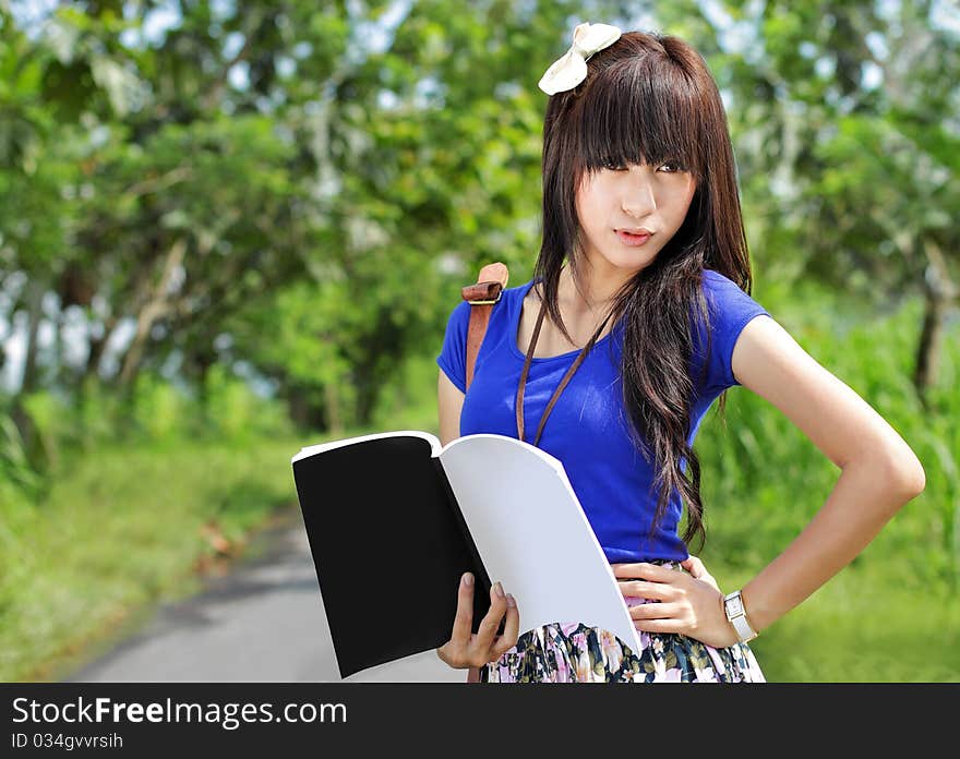 Gorgeous model posing and holding a book. Gorgeous model posing and holding a book