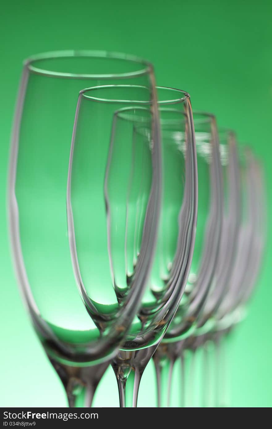 Empty champagne glasses on a green background