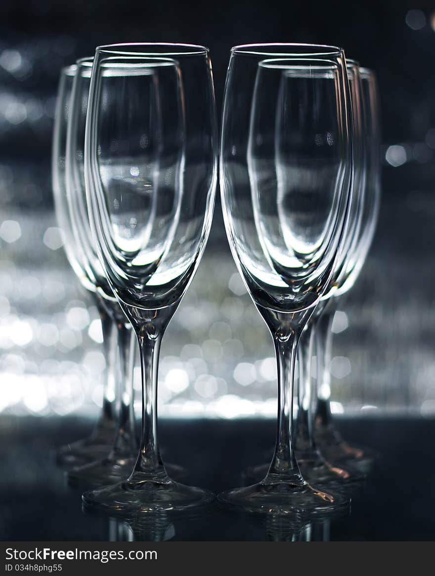 Empty champagne glasses on a green background