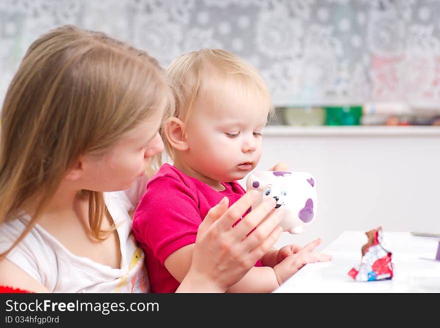 Young mother drink tea with daughter