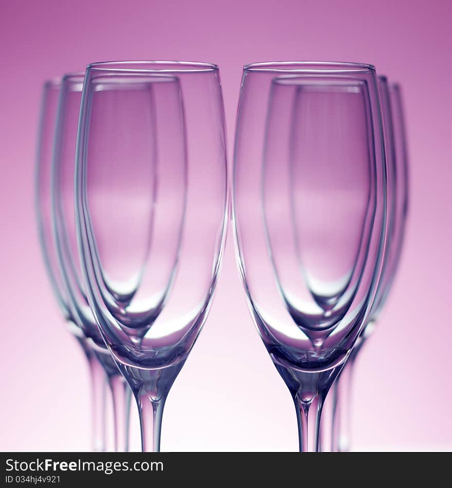 Empty champagne glasses on purple background