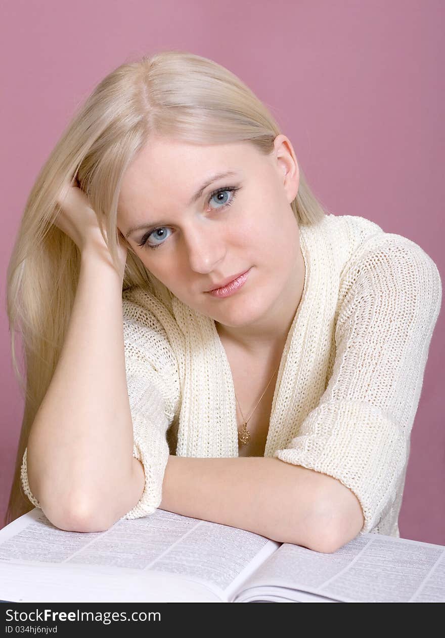 Studio portrait of teenage girl reading book. Studio portrait of teenage girl reading book