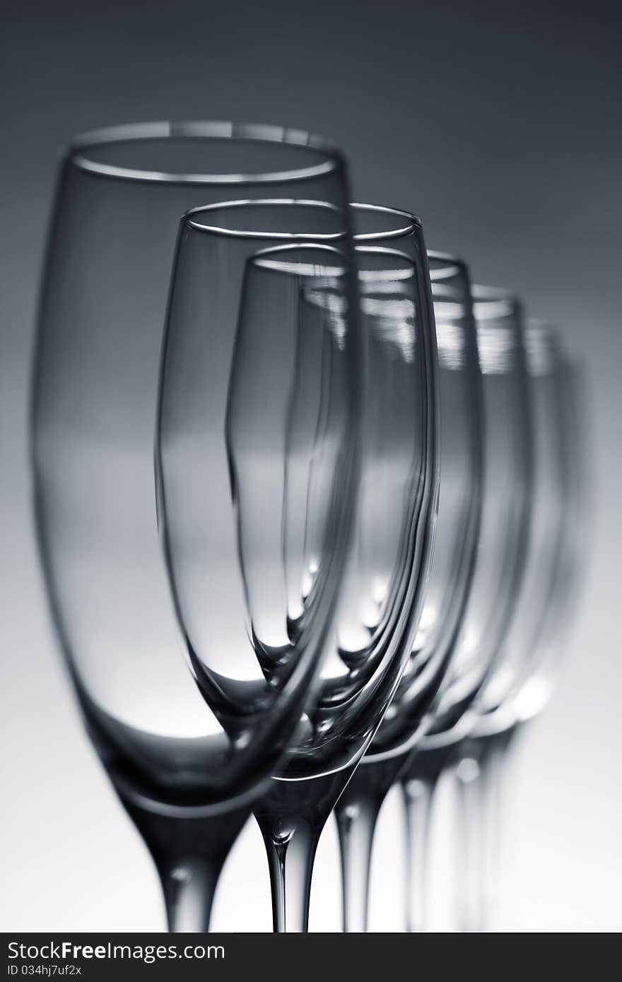 Empty champagne glasses on gray background