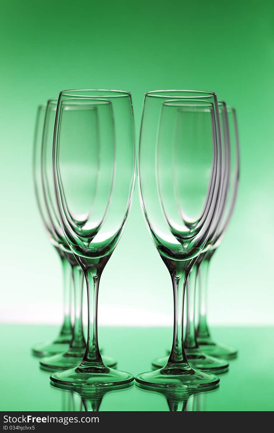 Empty champagne glasses on a green background