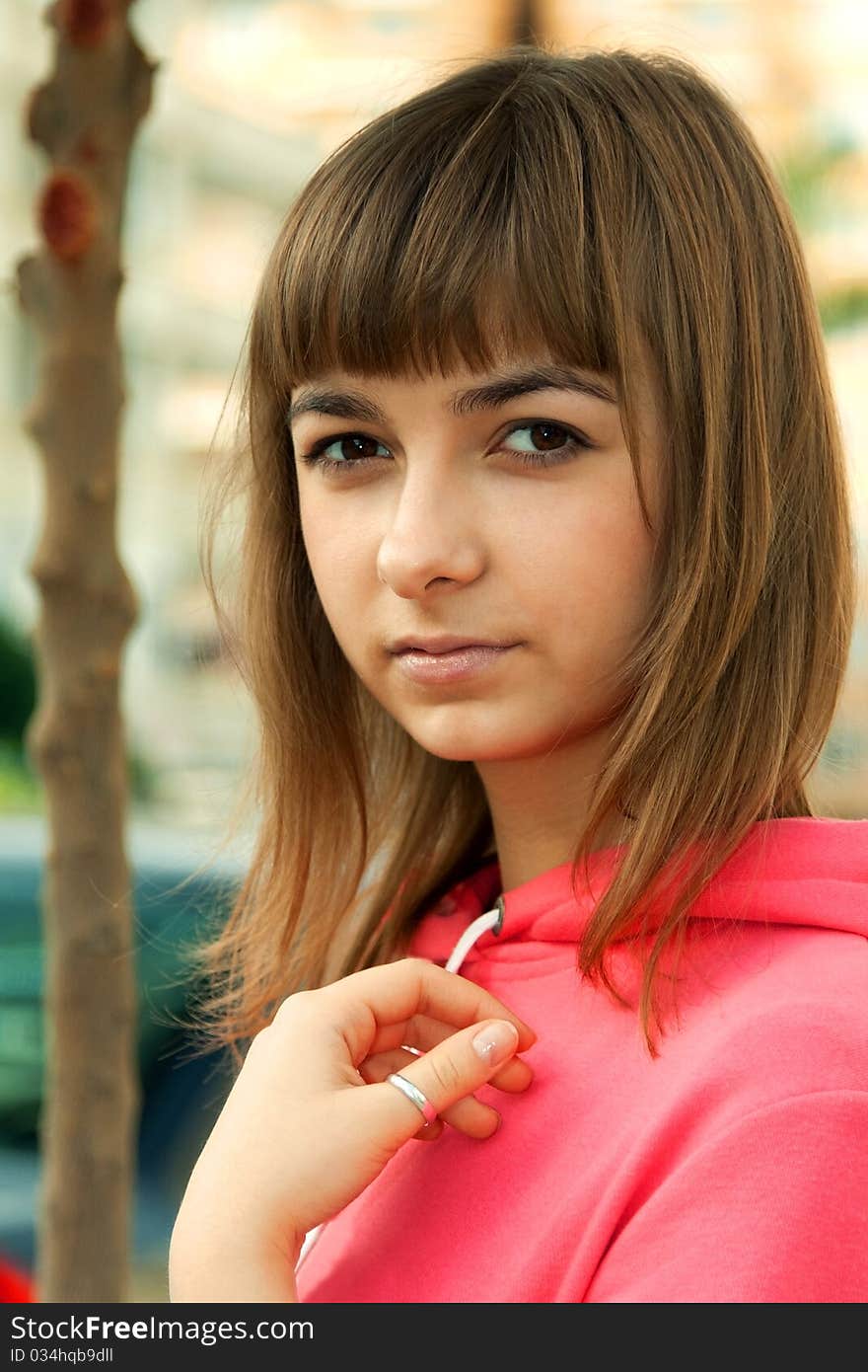 Portrait of a beautiful girl on a background of fine trees