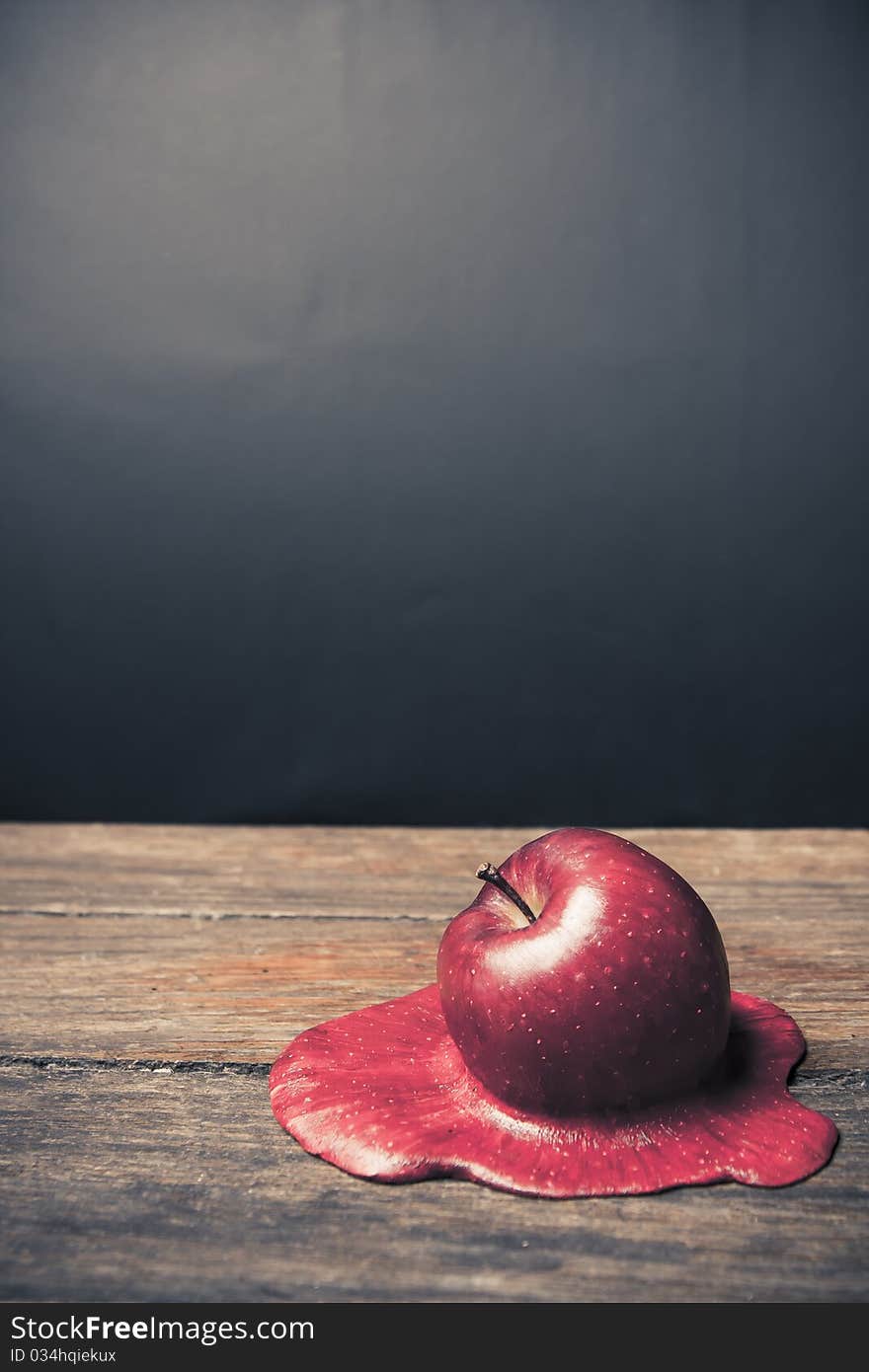 Conceptual photo of a melting apple. Conceptual photo of a melting apple