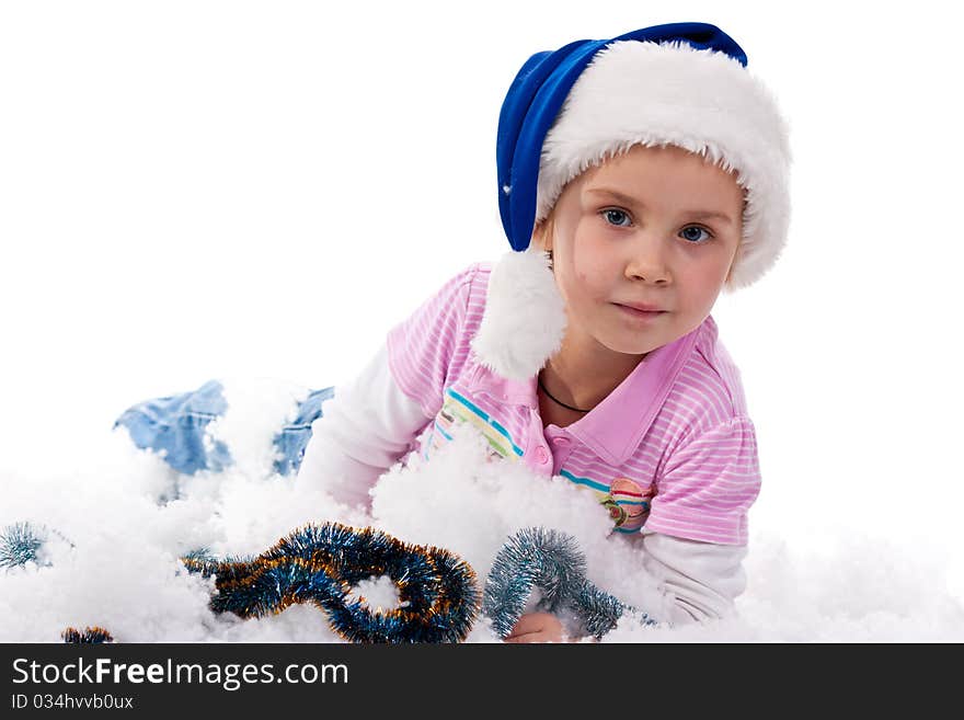 Beautiful girl in Santa's hat in tinsel and artificial snow isolated on white