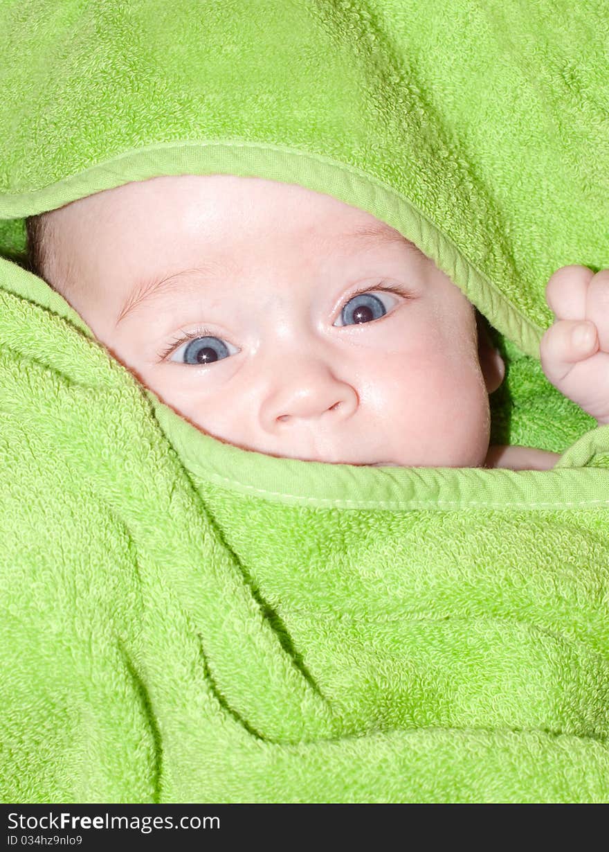 Baby looking out from under blanket. Baby looking out from under blanket.