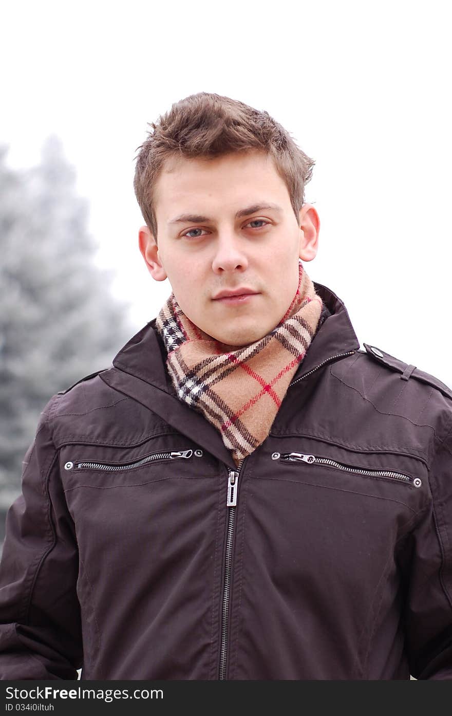 Outdoor winter portrait of a beautiful young man