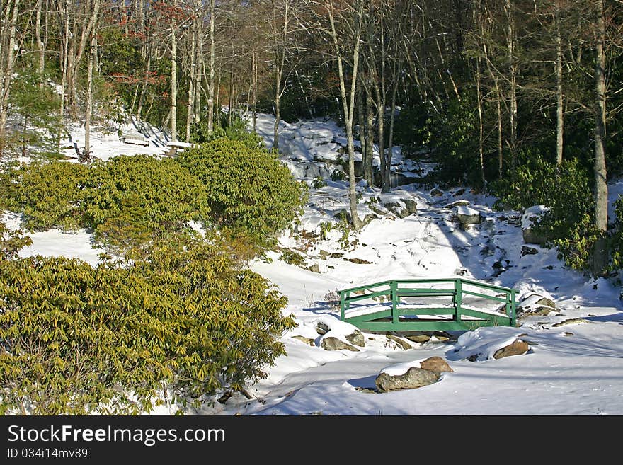 A footbridge at the base of the frozen waterfall in Newland, North Carolina. A footbridge at the base of the frozen waterfall in Newland, North Carolina