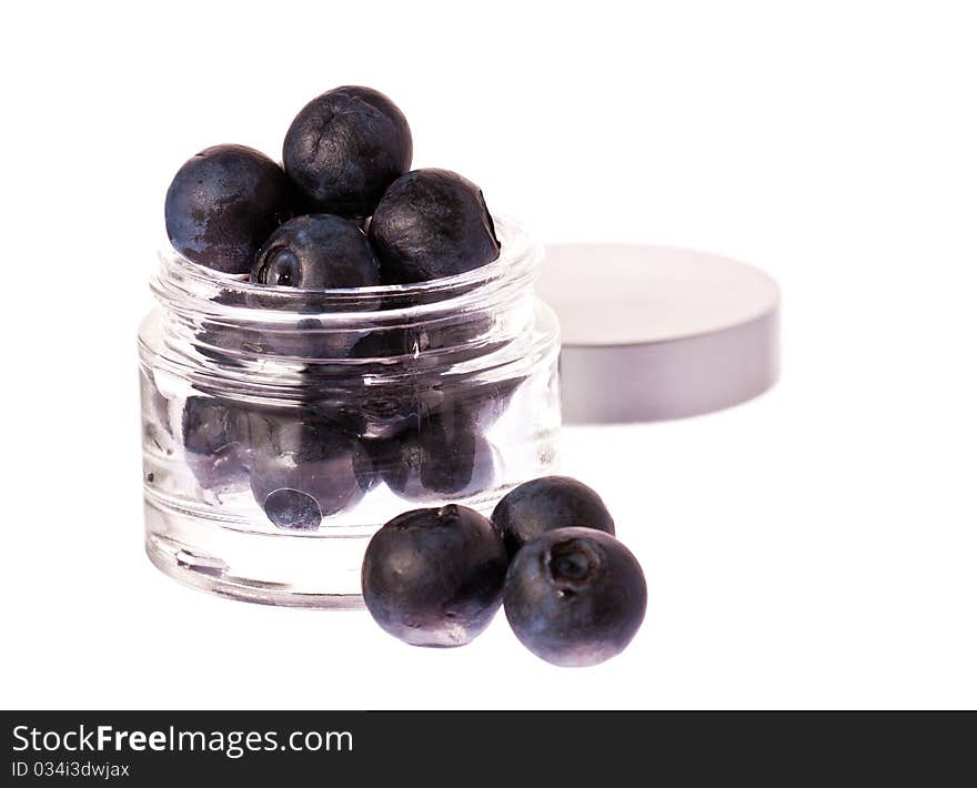 Fresh blueberries in a glass beauty cream jar. Isolated over white with clipping path. Fresh blueberries in a glass beauty cream jar. Isolated over white with clipping path.