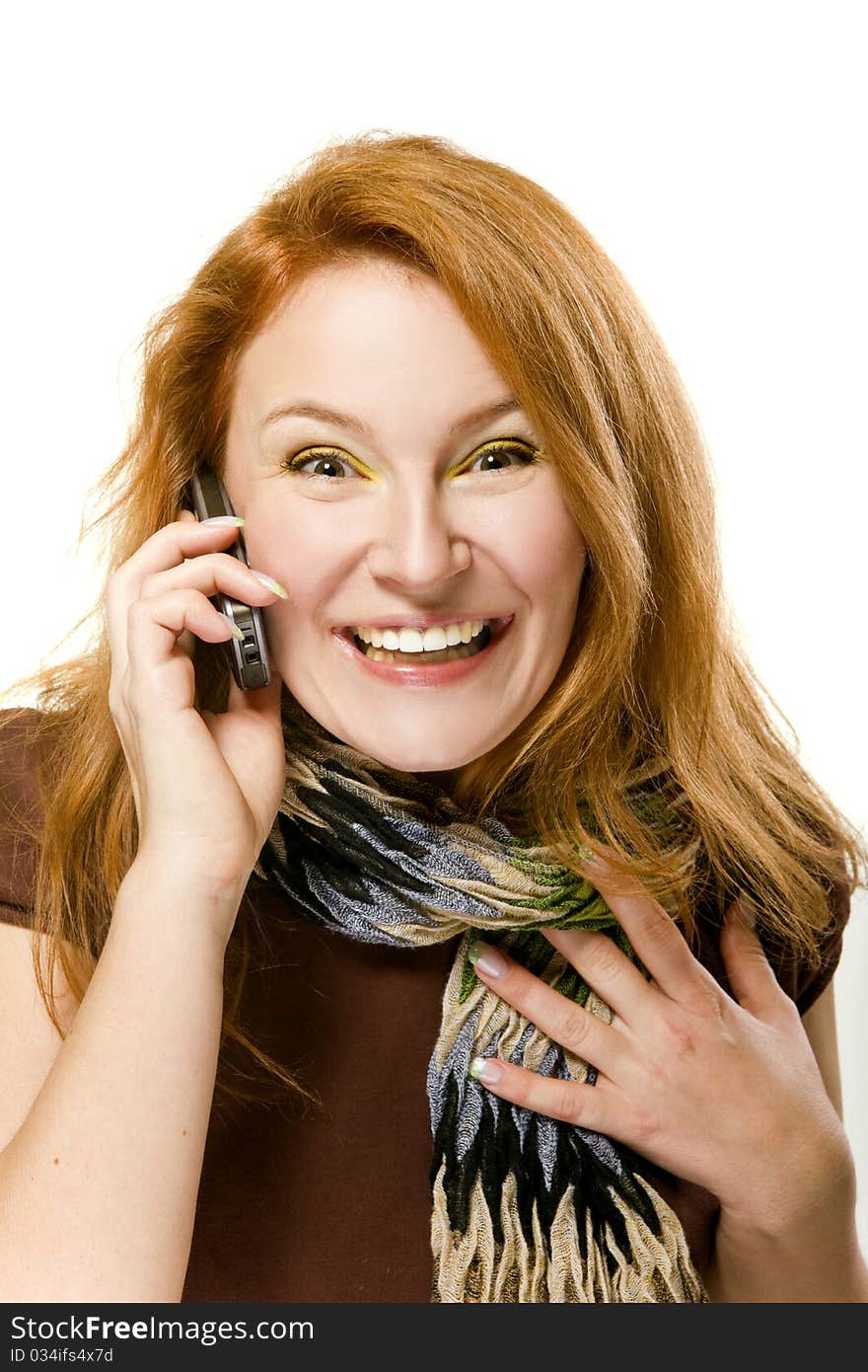 On white background Adult red-haired woman emotionally talking on the phone. On white background Adult red-haired woman emotionally talking on the phone