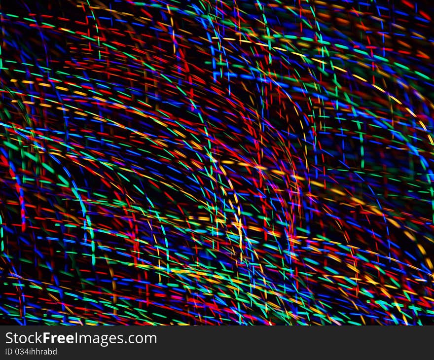 Abstract light patterns created with camera motion and colorful christmas lights.