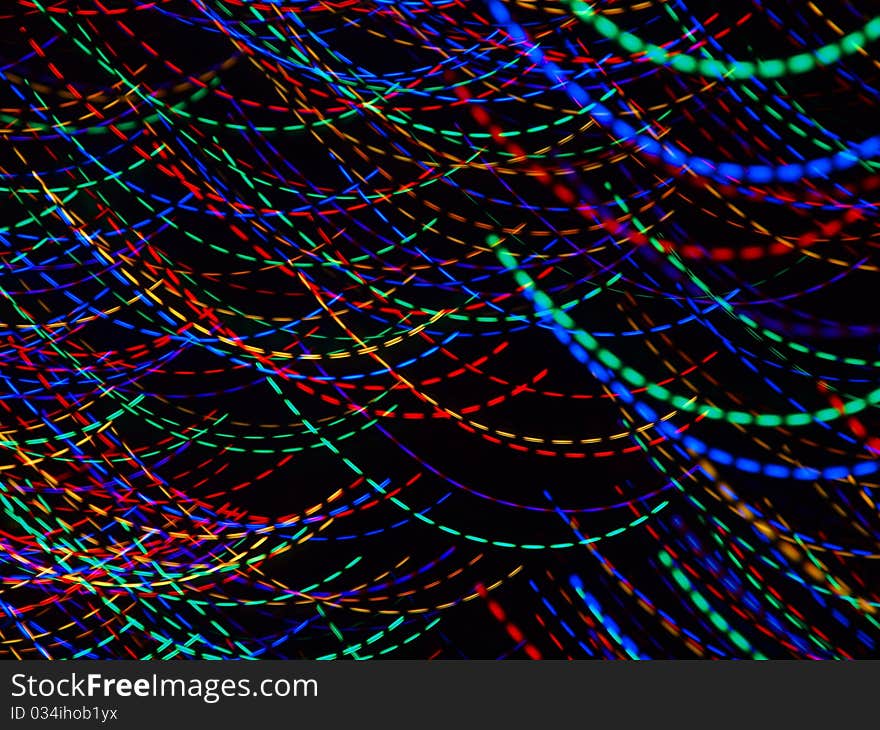 Abstract light patterns created with camera motion and colorful christmas lights.