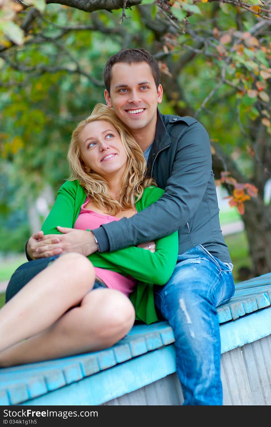 Beautiful young couple relaxing in a park