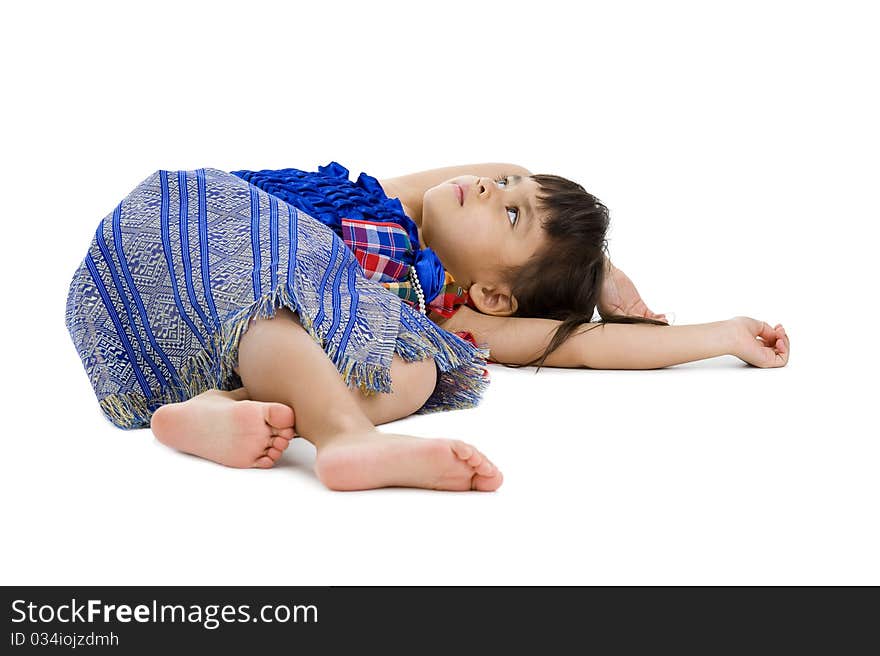 Cute little girl laying on the floor and looking up to the ceiling isolated on white background