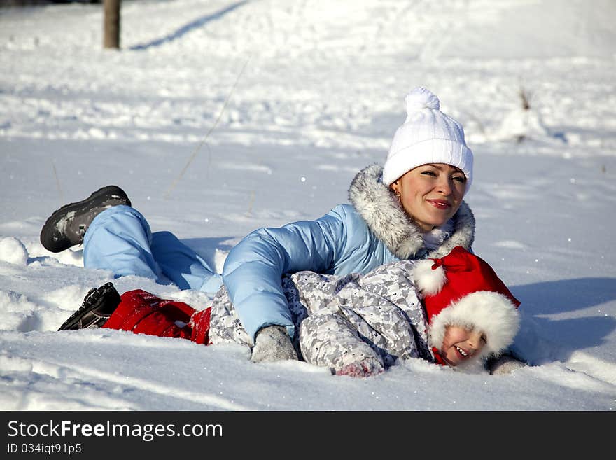 Mother and daughter playing in the snow