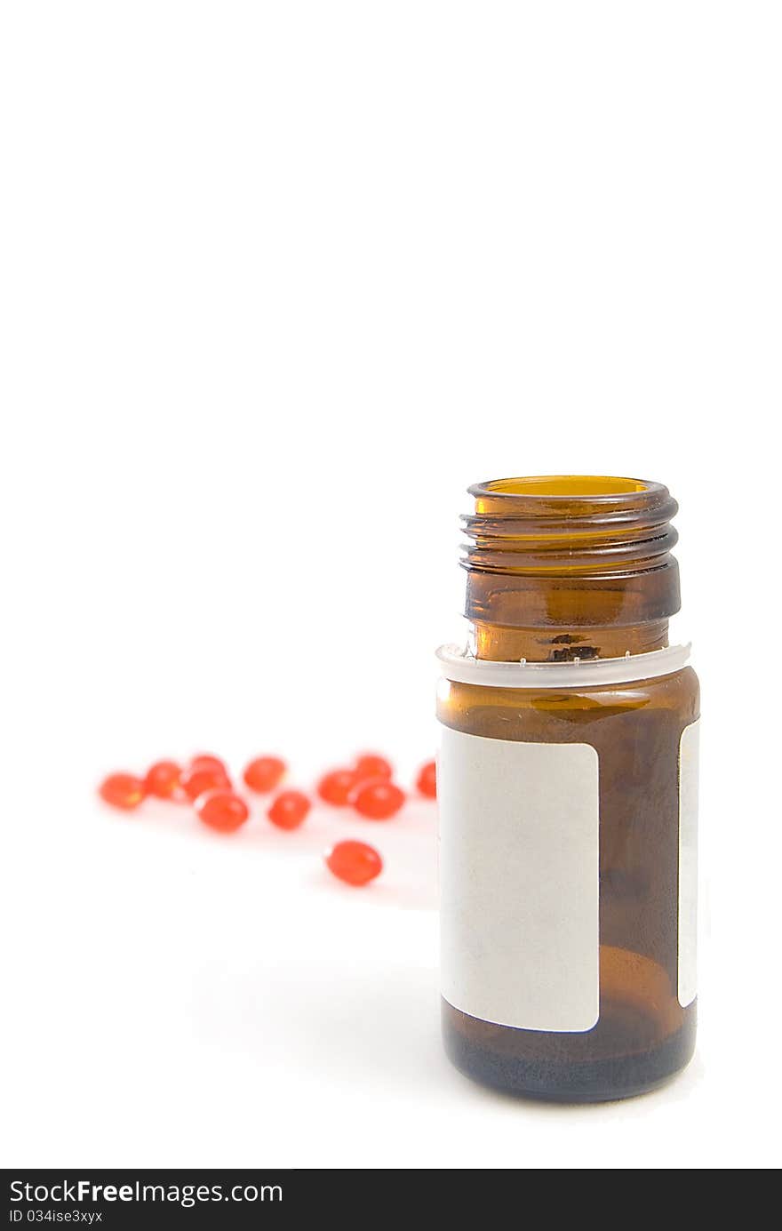 Overturned bottle and vitamins, are isolated on a white background