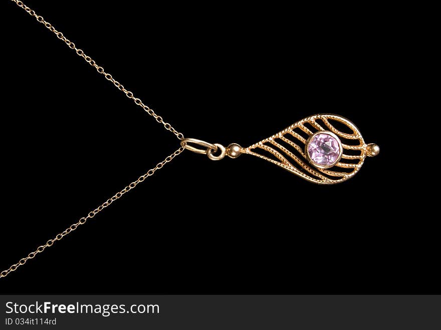 Gold coulomb with amethyst, is isolated on a black background