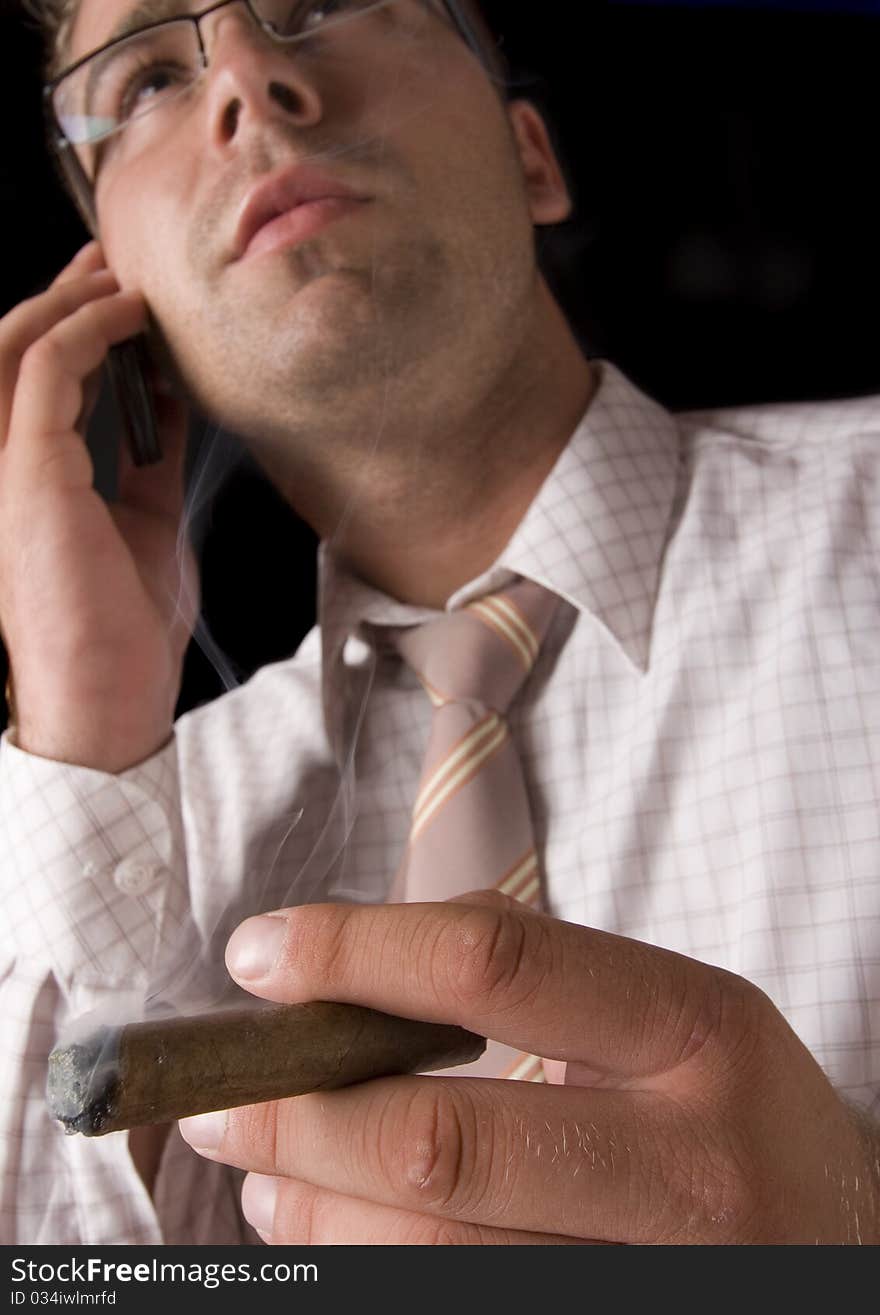 Businessman smoking cigar