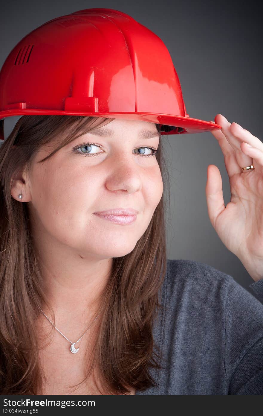 Portrait of young architect wearing red hardhat