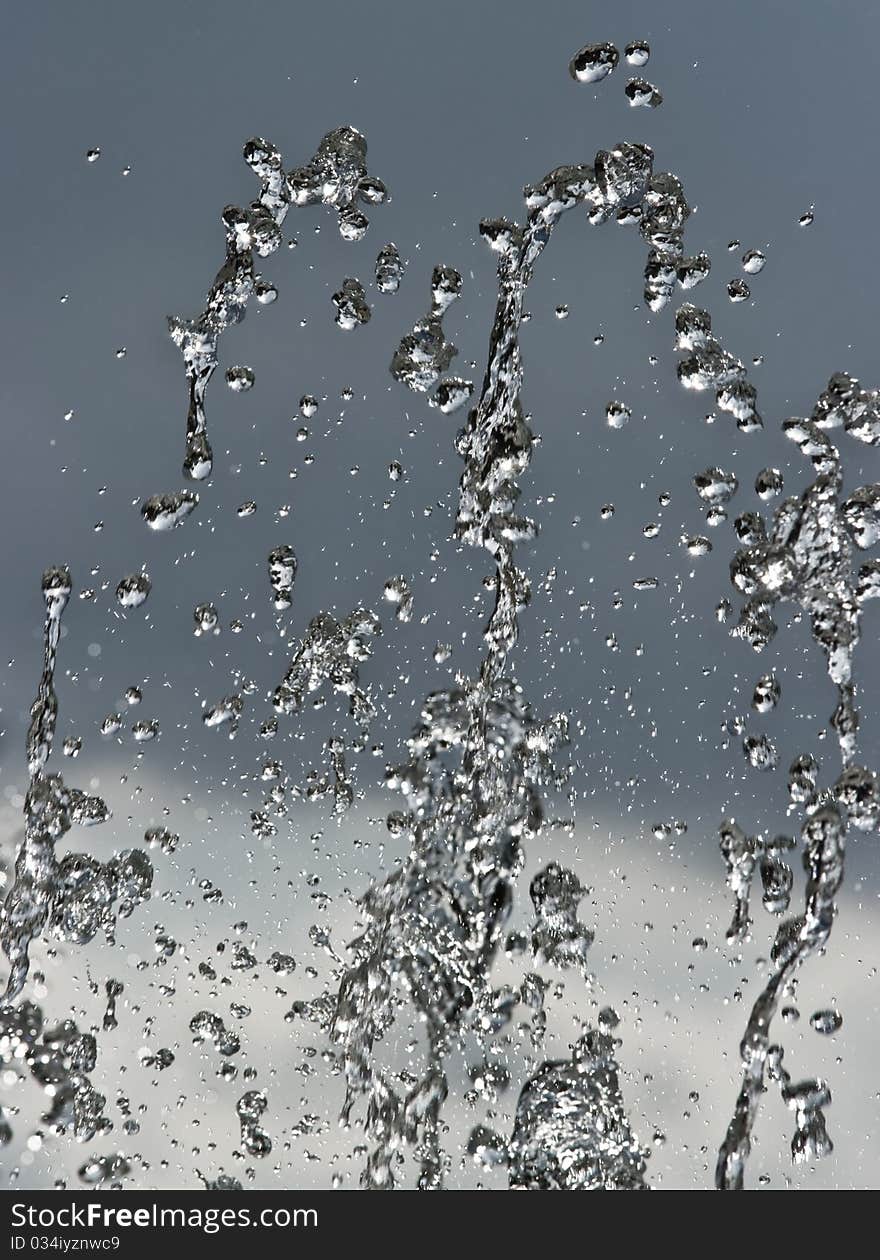 Water splashes over background of sky