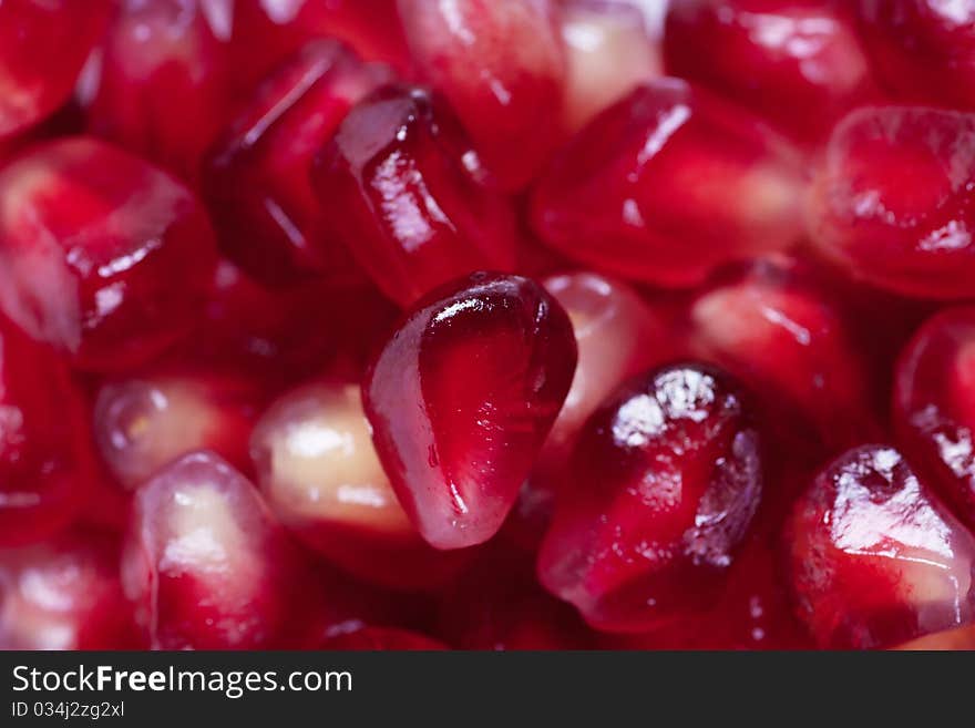 A background with a heap of pomegranate seeds